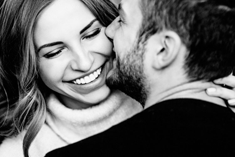 Husband kissing wife on the cheek