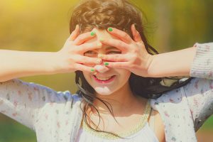 A young woman blocking her face from the sunlight.
