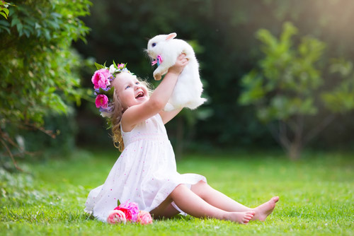 Young toddler playing with a bunny