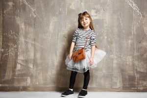A girl carrying a trendy school bag.