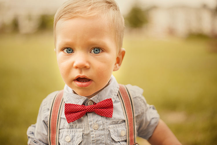 A bow wearing a polka-dot bow tie with his country outfit.