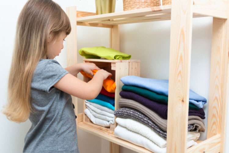 Girl sorting through clothes