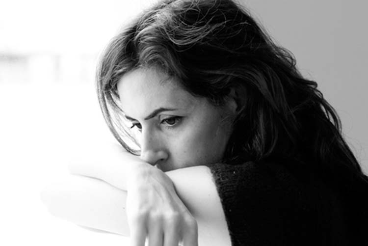 Black and white image of a sad woman