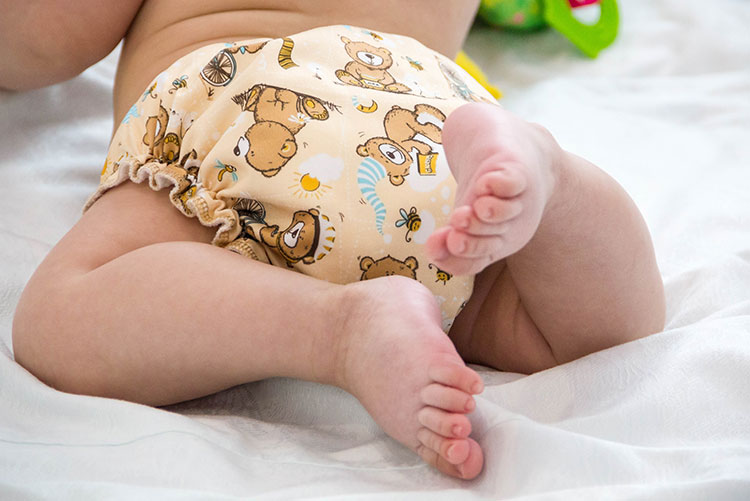 A newborn wearing a cloth diaper.