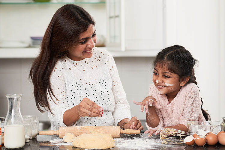 A mother and daughter having fun while cooking.