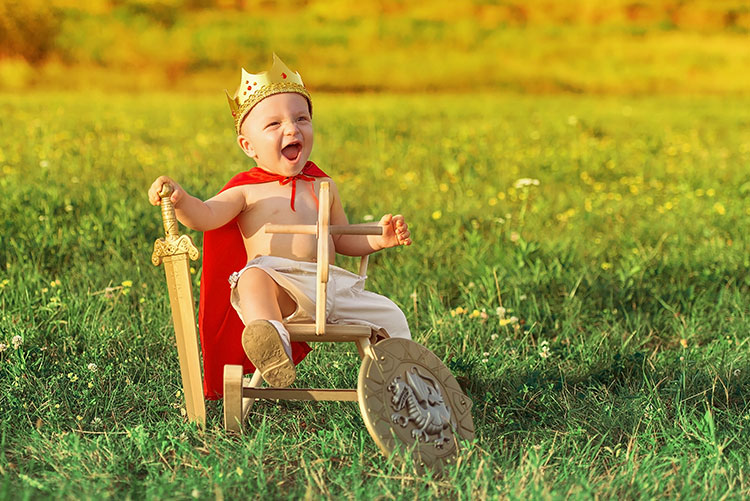 A boy dressed as a king.