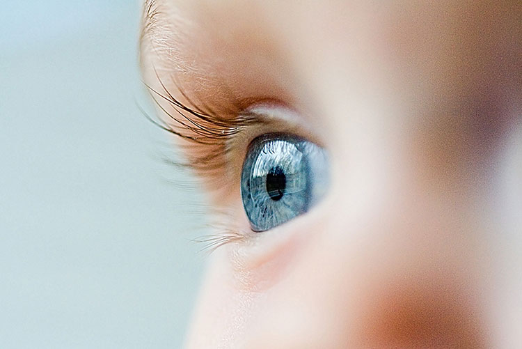 A baby boy with beautiful blue eyes.