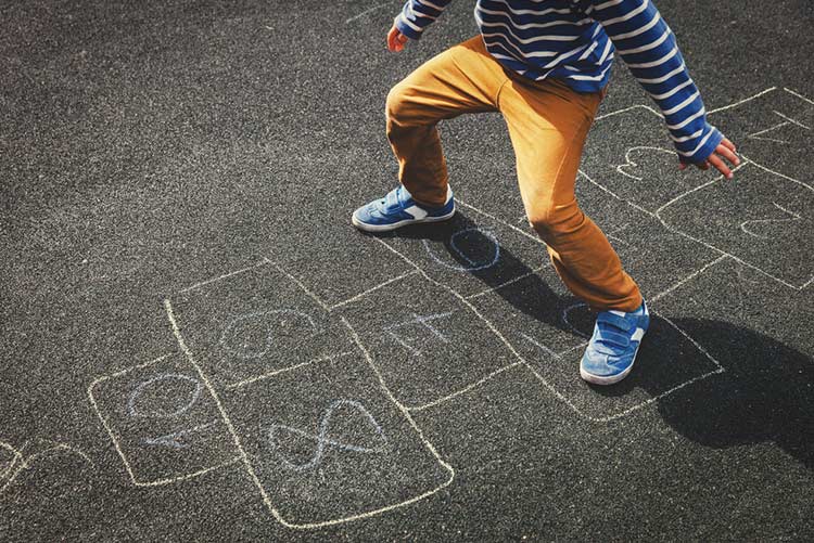 Child hopping through the Hopscotch court