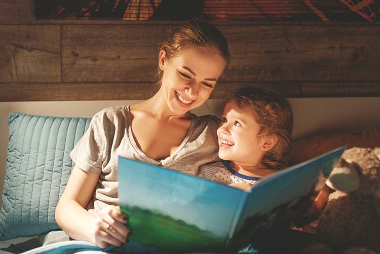 A boy enjoying bedtime stories with his mom.