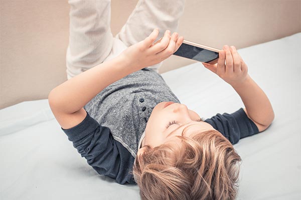 A boy hooked to a mobile phone.