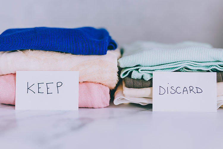 Clothes stacked up in two piles.