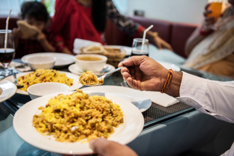 Picture of a hand serving rice