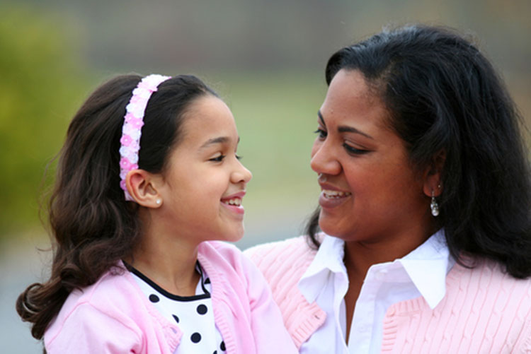 Mother and daughter smiling at each other