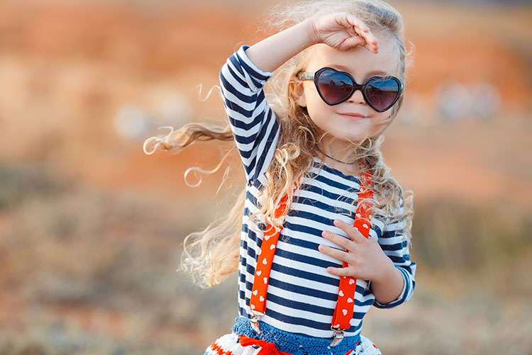 A girl wearing heart-shaped sunglasses.