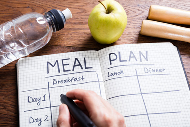 Person writing down a meal plan