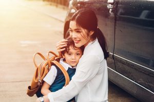 Mother hugging her child before school