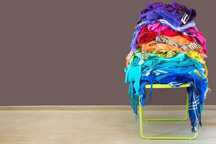 Unused clothes stacked up on a chair