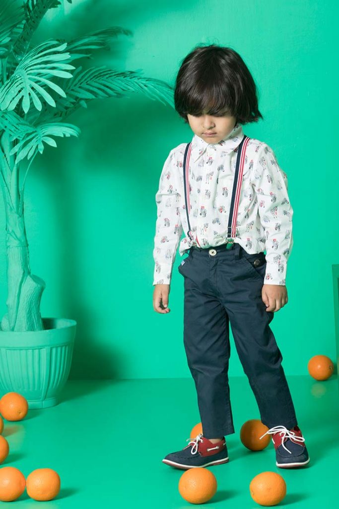 A young boy wearing a reversible shirt.