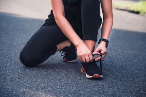 Woman tying laces of her running shoe!