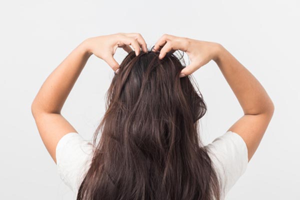 Woman massaging her scalp