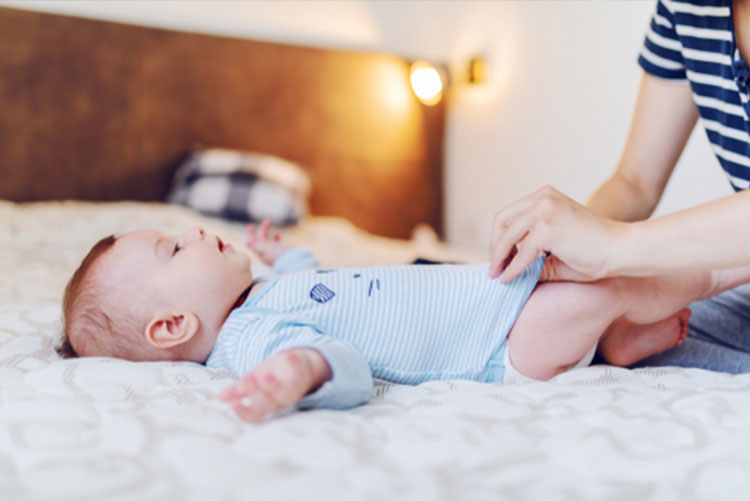 Mom dressing baby