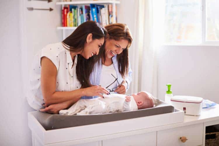 Grandmother and mother looking at the baby