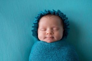 Baby swaddled in a blue blanket