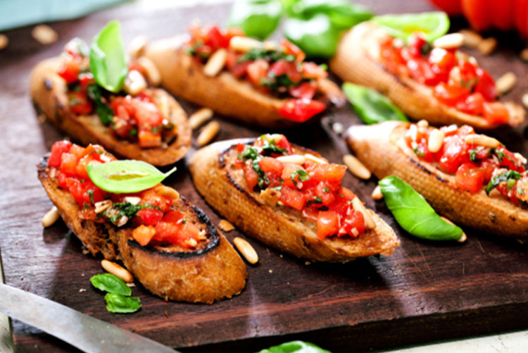 Bruschetta placed on a wooden serving board