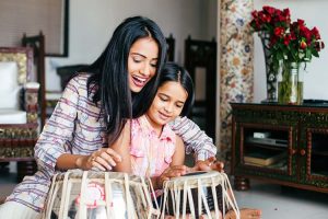 A mother and daughter duo playing the tabala.