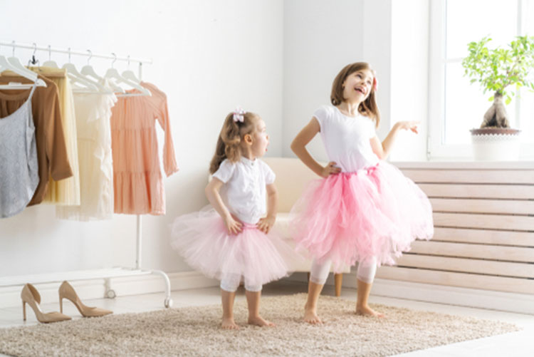 Two girls wearing tutu skirts and posing