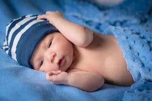A baby boy wearing a blue beanie.