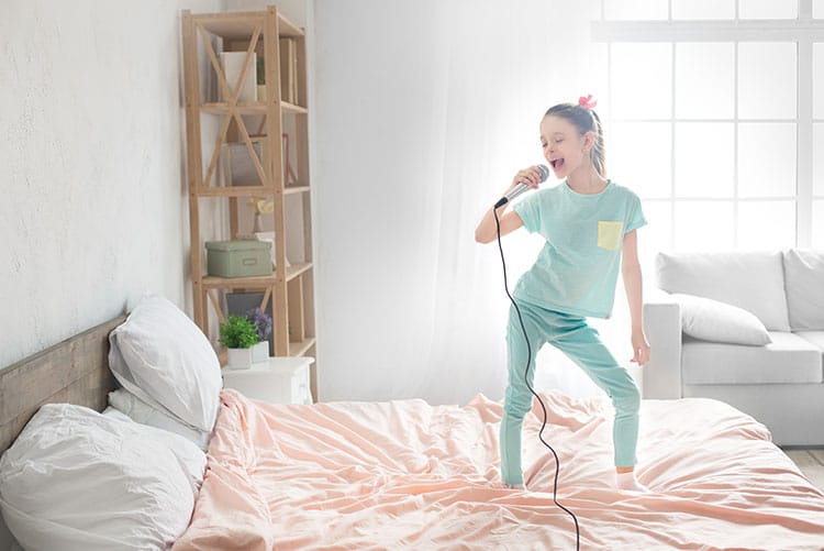 A girl dancing on her bed