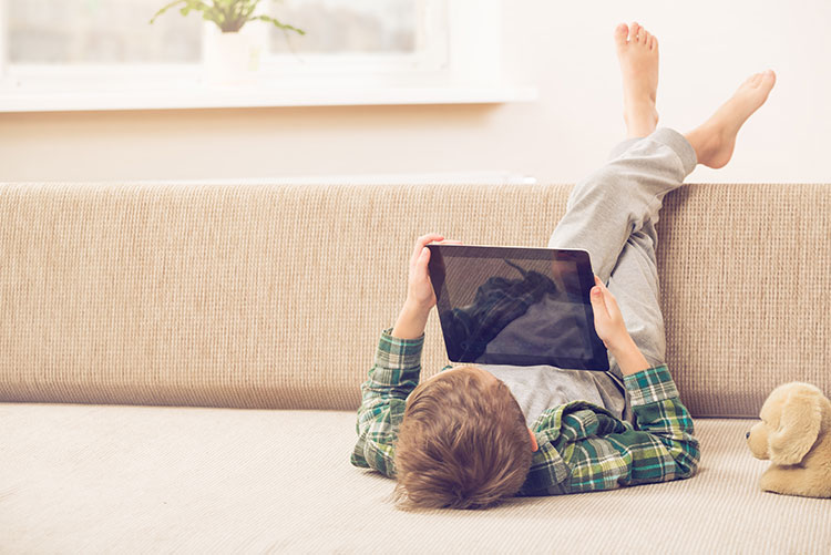 A young watching a movie on his tab.