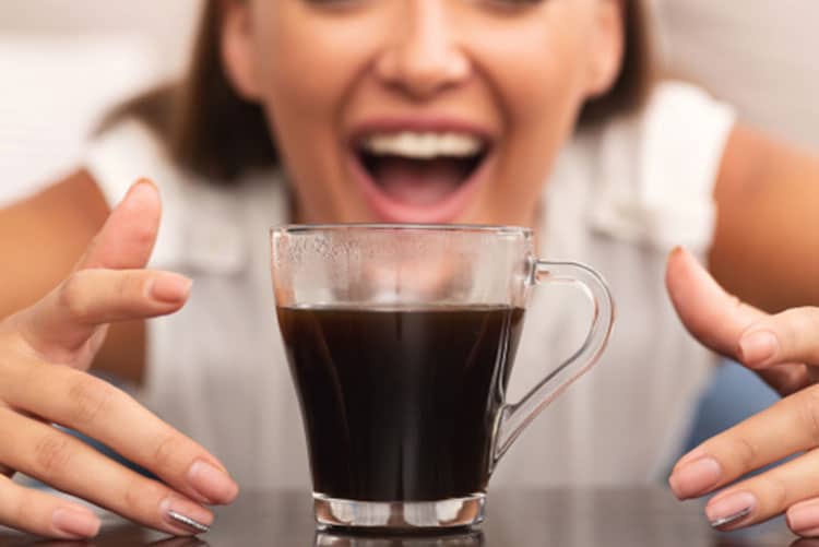 Woman reaching out for coffee