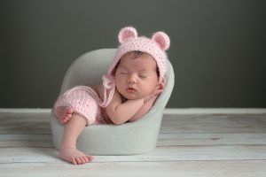 Baby sleeping on a small chair