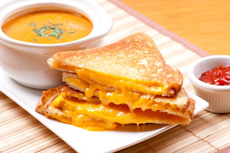 Grilled cheese sandwich served with tomato soup and ketchup!