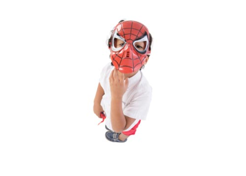 Young kid wearing a Spiderman mask, looking up at the camera