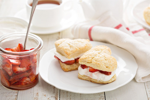 Strawberry shortcakes served with a jar of strawberries