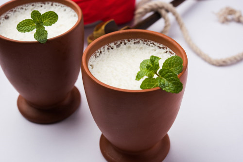 Indian drink or Lassi served with basil in a clay mug