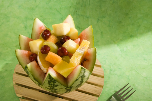 Carved watermelon stuffed with muskmelon, apples and berries