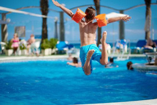 Young kid diving in a pool