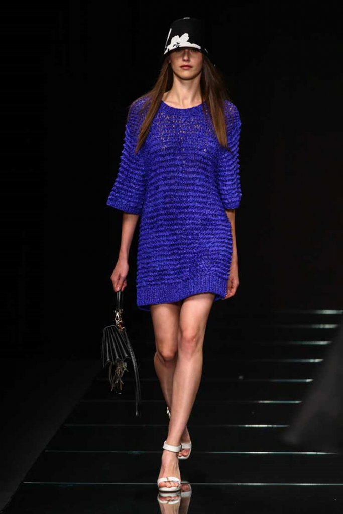 Model walks the ramp wearing a Classic Blue dress paired with a cap and white shoes!