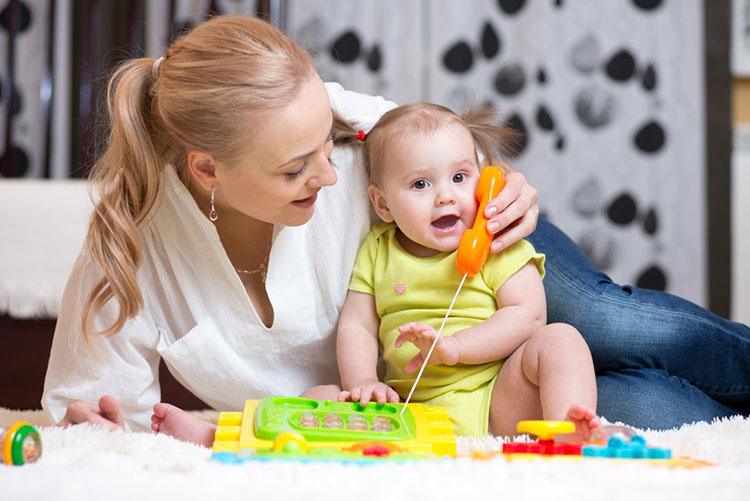 Mother and toddler playing with a makeshift phone!