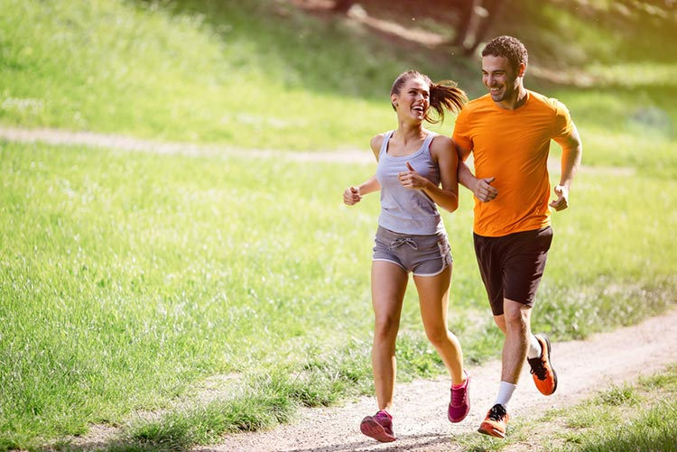 A couple running together on the pavement!