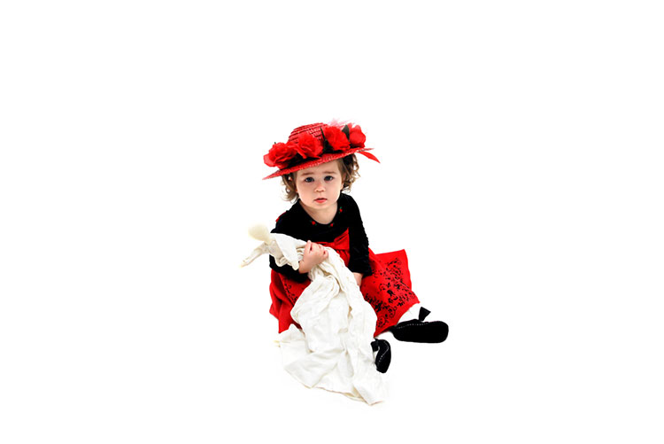 Adorable little girl wearing a black and red dress paired with a flowery hat!