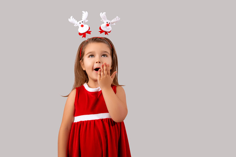 Adorable young girl in a red and white Christmas outfit paired with reindeer hat!
