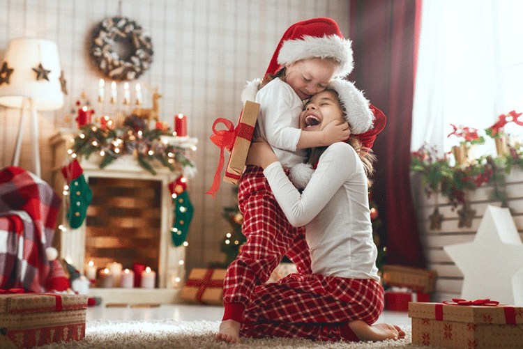 Sisters hugging each other lovingly in red Christmas pyjamas and white tops!