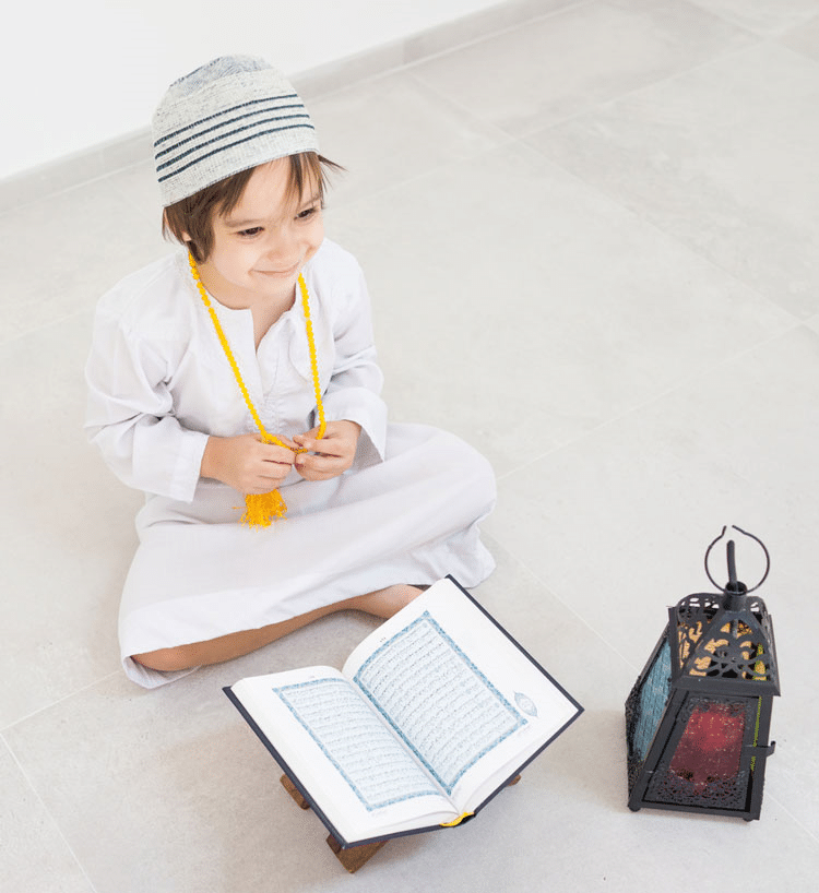 Young Muslim boy reading the Quran!