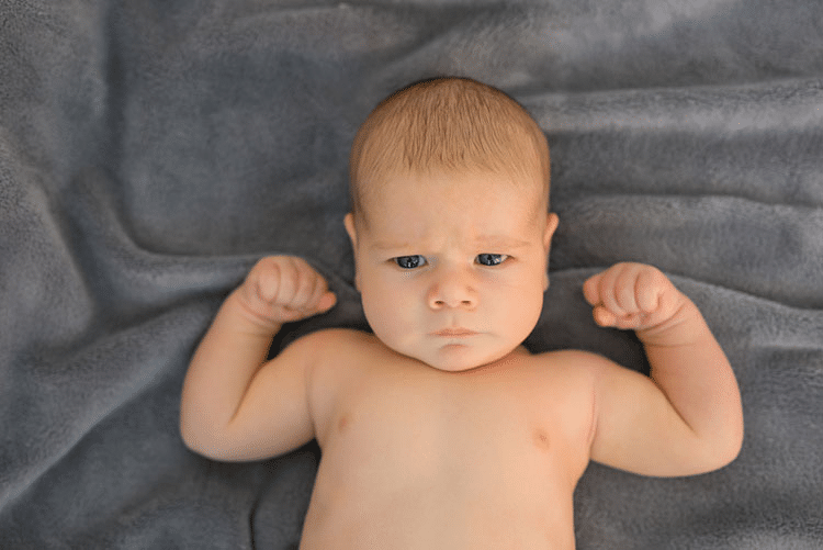 An infant showing off his muscles!