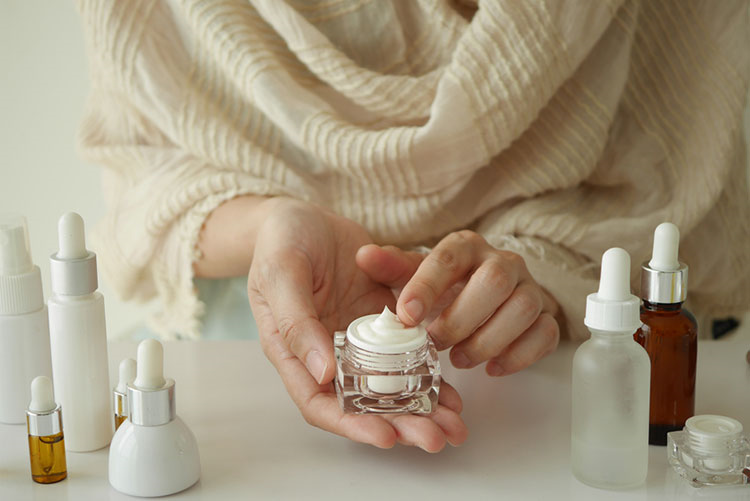 Woman applying moisturiser in the winter